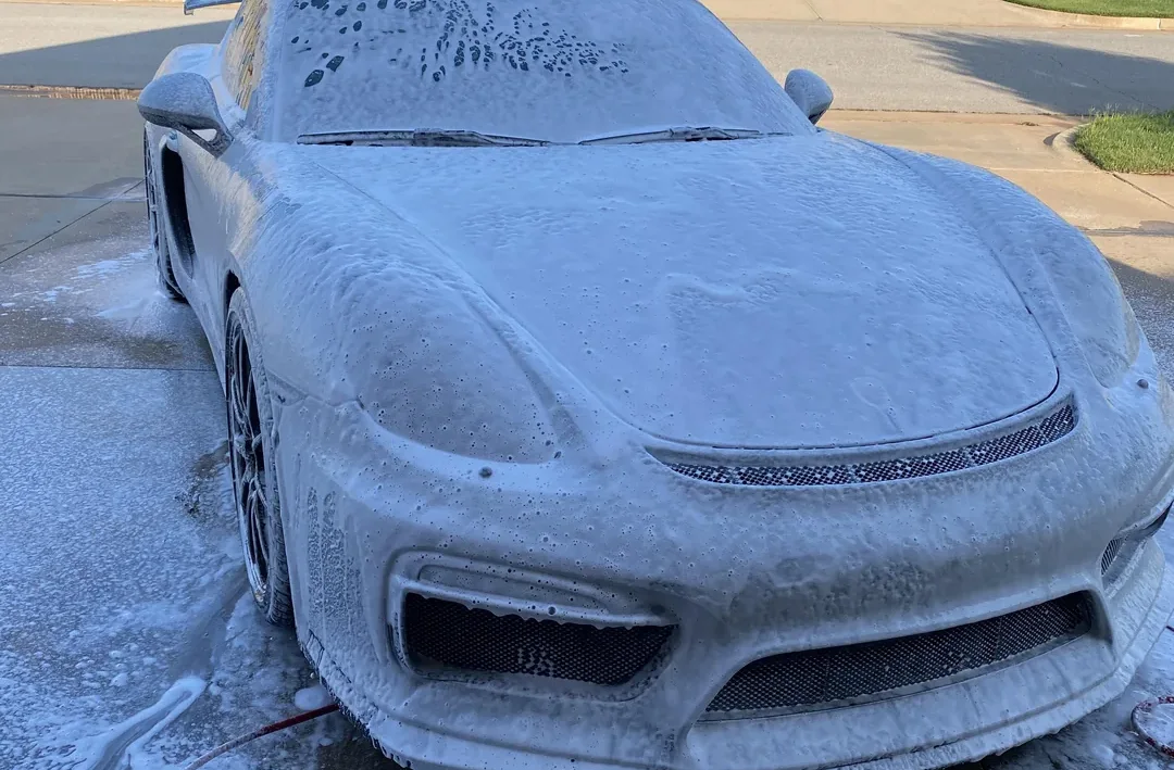 Sports car covered in cleaning foam